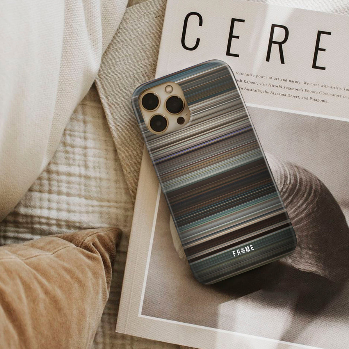 logan Frome phone case next to interior items