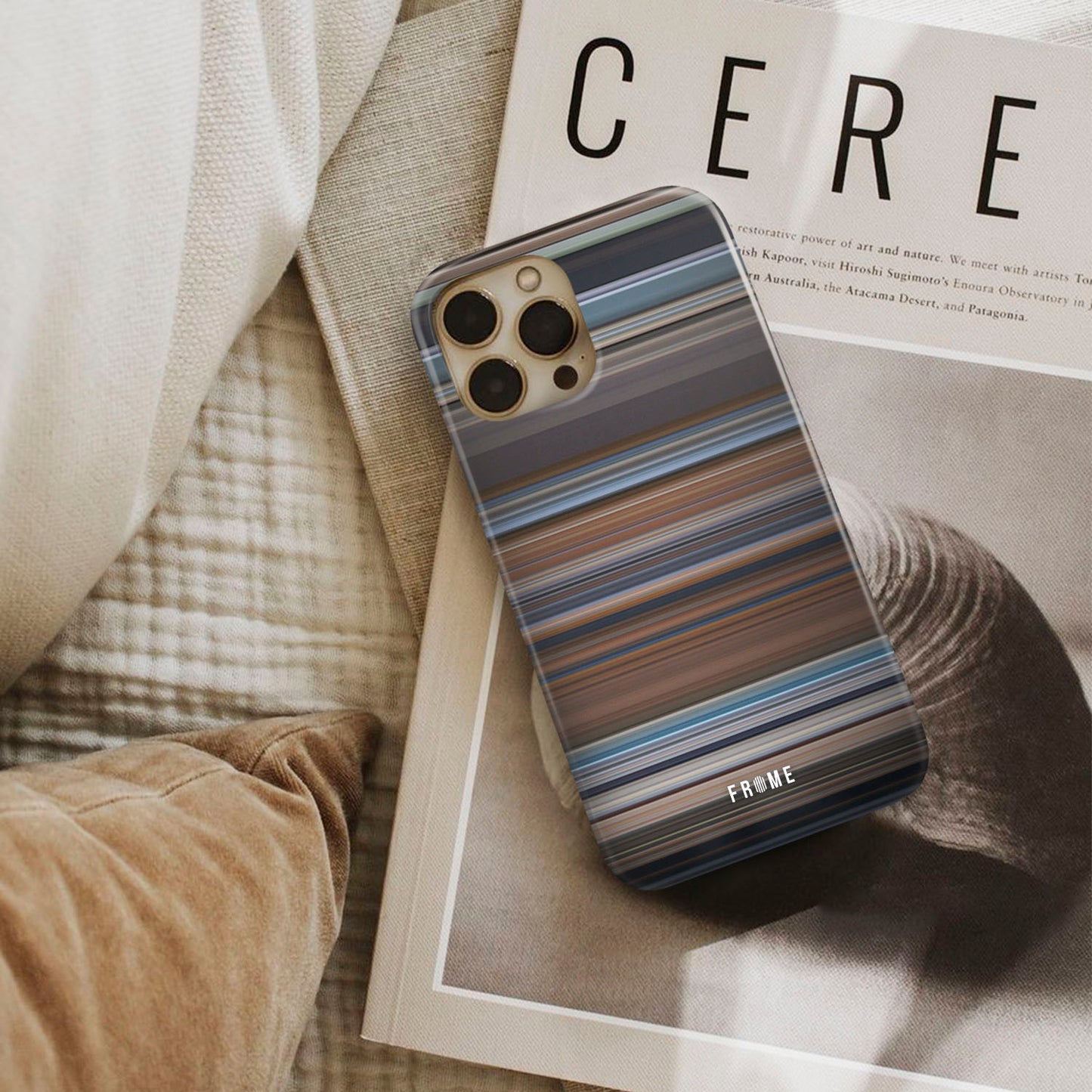 a ghost story Frome phone case next to interior items