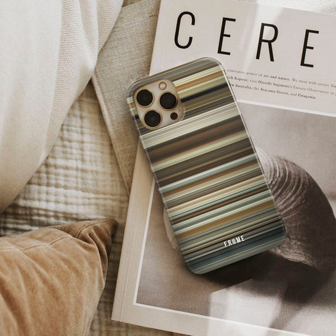 about time Frome phone case next to interior items