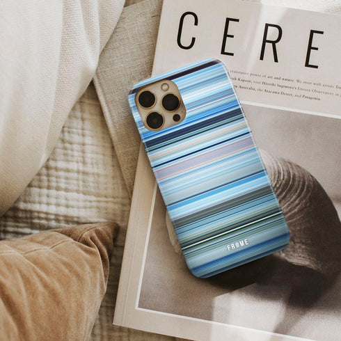 happy feet Frome phone case next to interior items