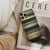 nope Frome phone case next to interior items