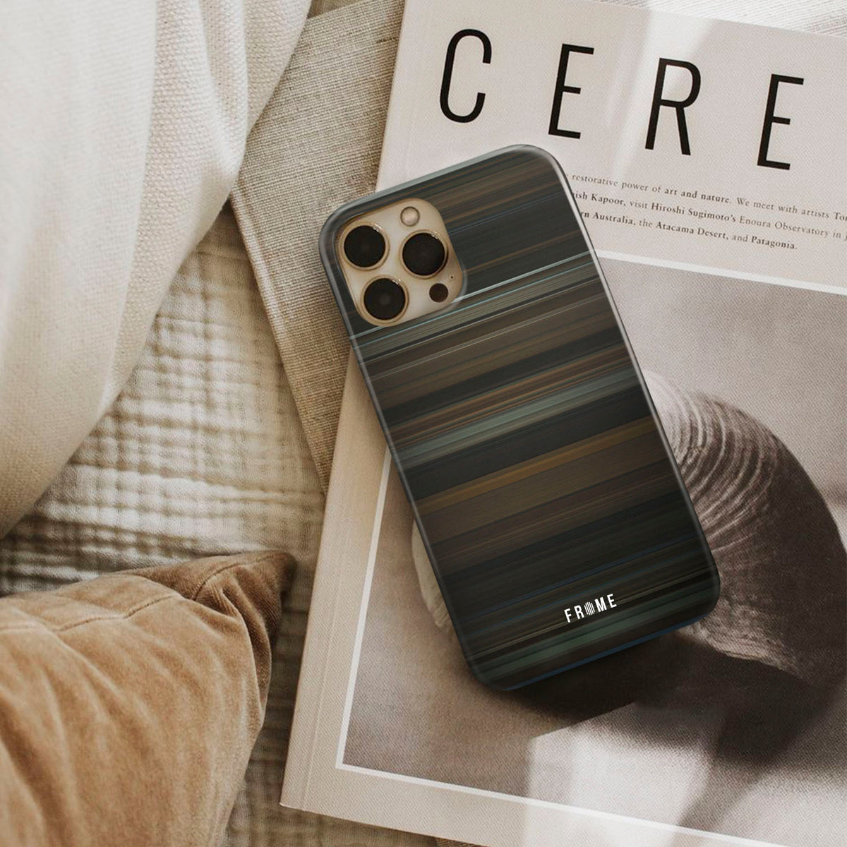 obsession Frome phone case next to interior items