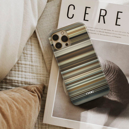 about time Frome phone case next to interior items